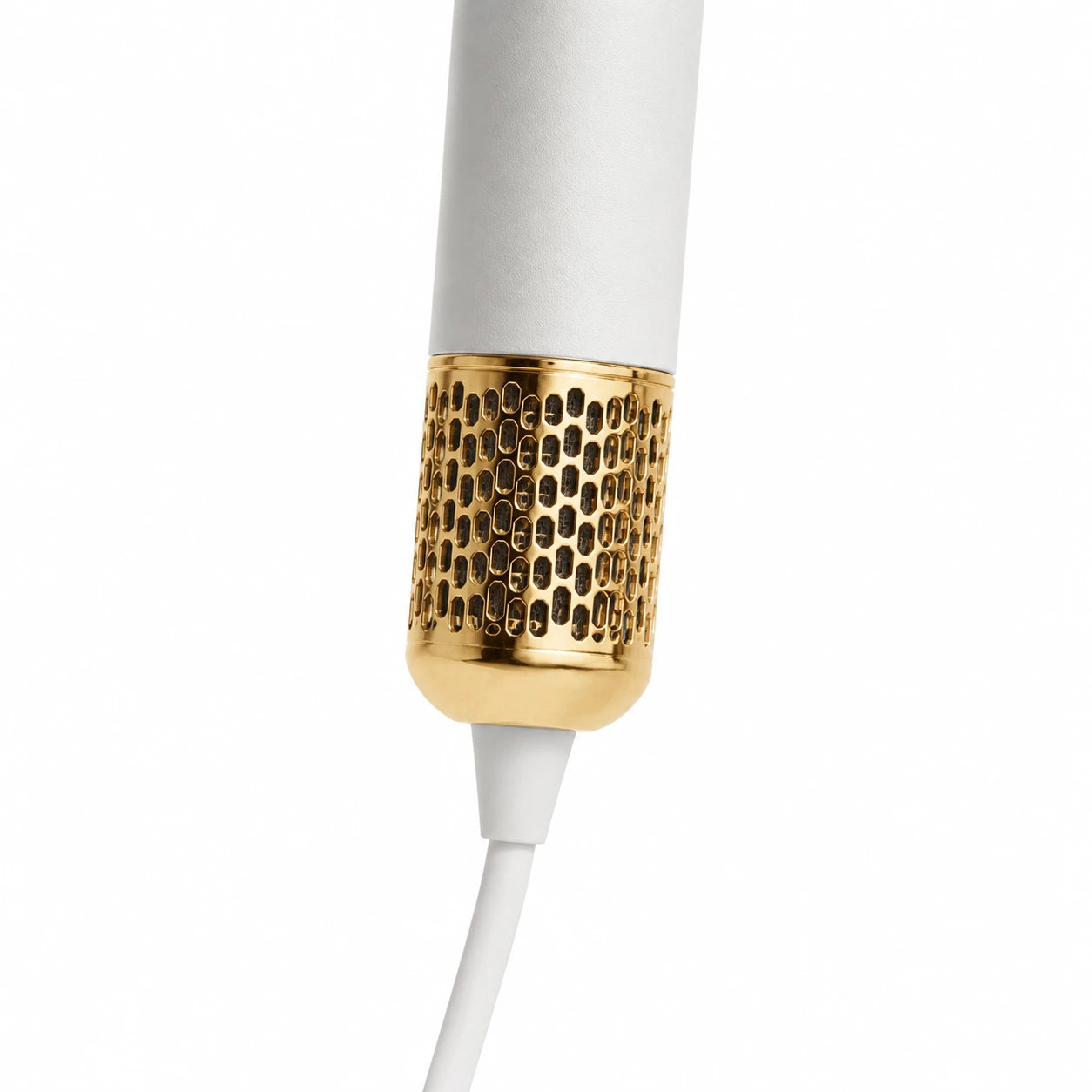 Close-up of the white AeroPro hair dryer with gold air outlet and white cord